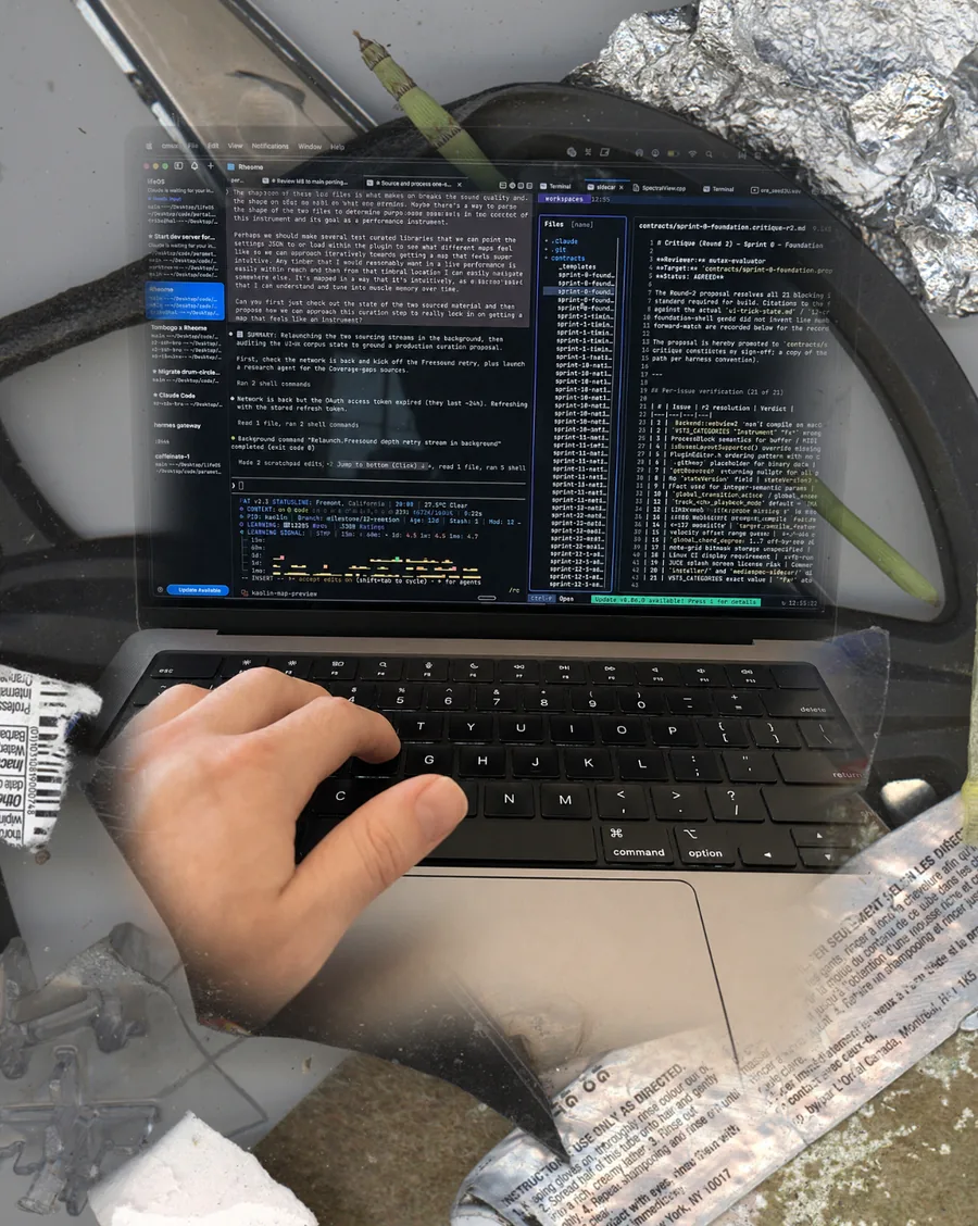 A laptop running a multi-agent coding harness — tiled terminal sessions and a critique file — collaged into a studio worktable of foil, brushes, and torn labels, a hand on the keyboard.